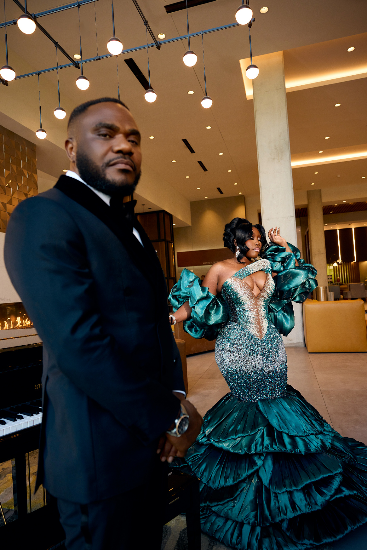 Arinze and Mary holding hands by their wedding car